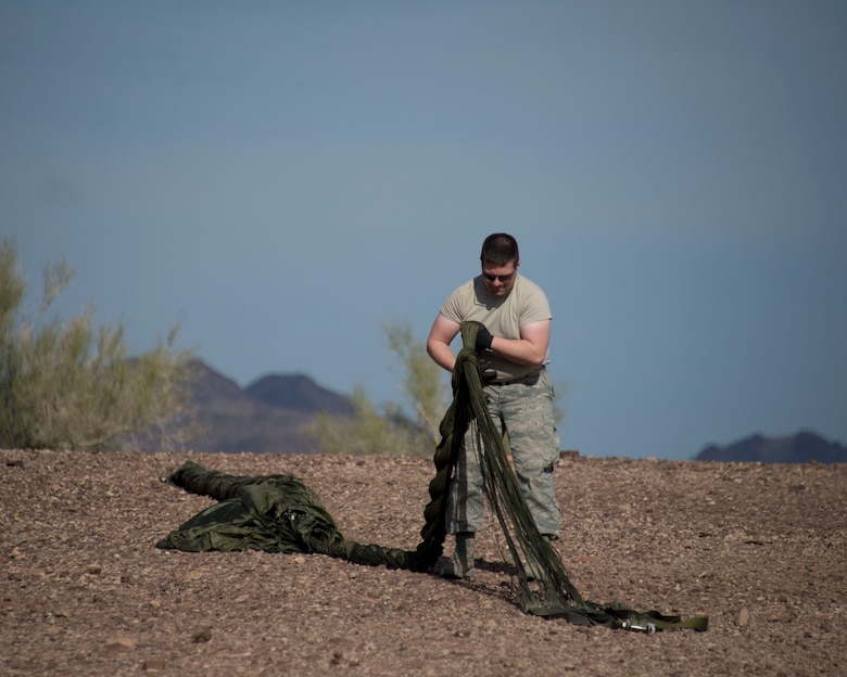 Senior Airman Trevor Norman, 133rd Logistic Readiness Squadron, Small Air Terminal Section, ties the 550 cords into a braid in Yuma, Ariz., Feb. 25, 2014. Norman is getting the parachute ready to place into a bag and transport. 
(U.S. Air National Guard photo by Tech. Sgt. Amy M. Lovgren/Released)