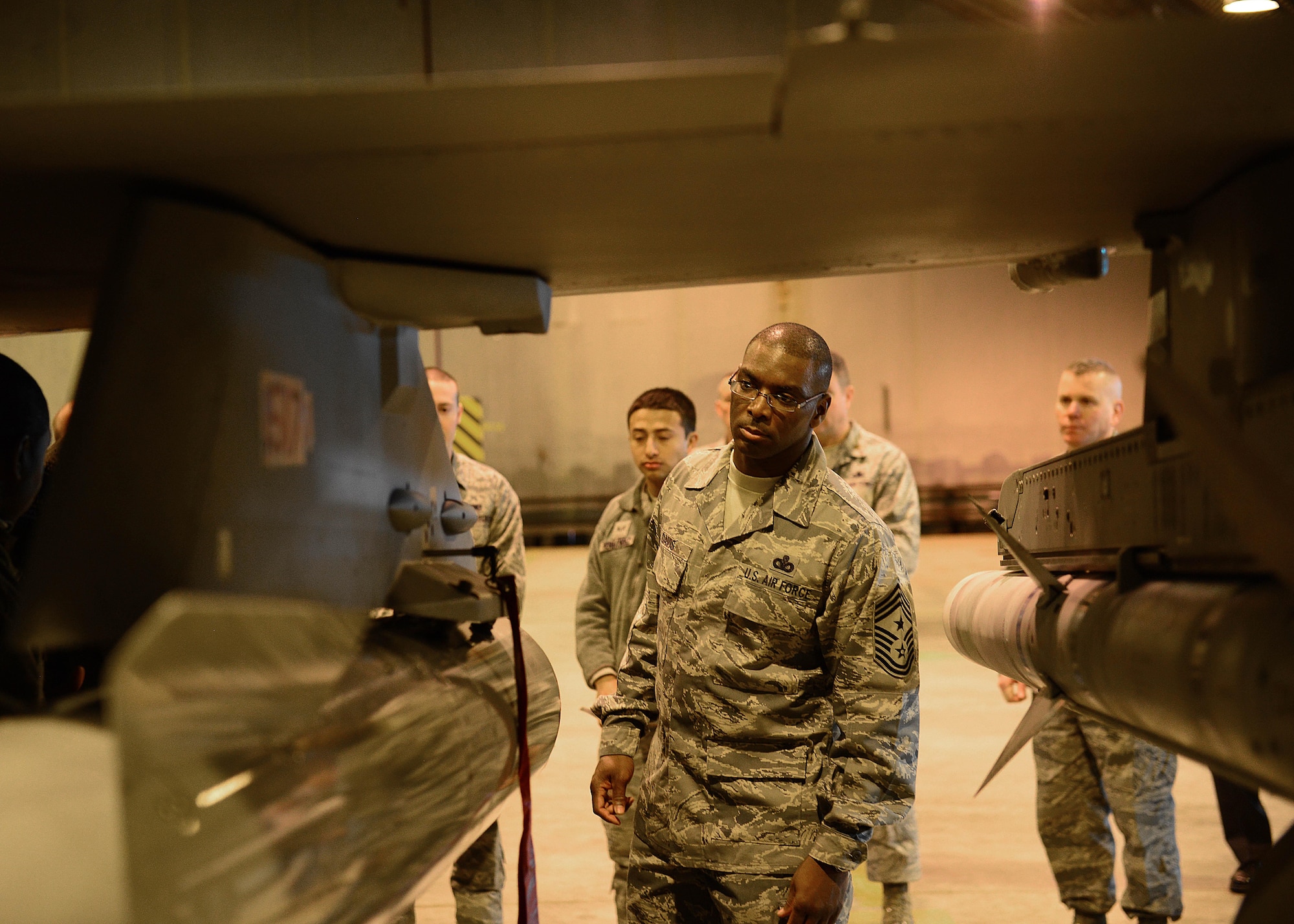 Chief Master Sgt. James E. Davis, U.S. Air Forces Europe and U.S. Air Forces Africa command chief, inspects munitions on an F-16CM Fighting Falcon during a visit, March 5, 2014, at Aviano Air Base, Italy. Davis is the senior enlisted advisor to the commander on all matters affecting the readiness, training, professional development and effective utilization of more than 21,000 enlisted force personnel. (U.S. Air Force photo/Airman 1st Class Ryan Conroy) 