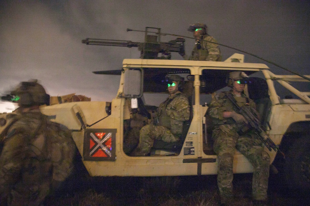Army Rangers wearing night vision goggles provide security during a multilateral airborne operation on Tyndall Air Force Base, Fla., March 3, 2014.