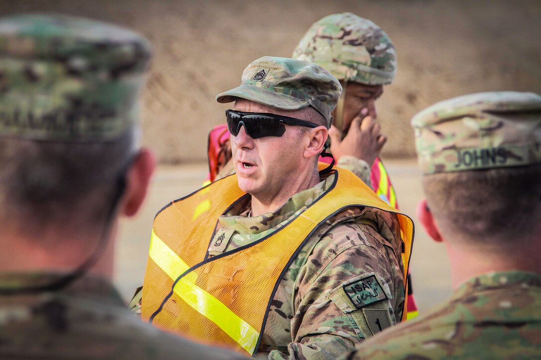 U.S. Army Sgt. 1st Class Thomas Maia, center, gives a safety briefing before the Schützenschnur qualification range on Kandahar Airfield, Afghanistan, March 9, 2014. Maia is assigned to 1st Infantry Division's Headquarters Company, 1st Combat Aviation Brigade. The Schützenschnur, which can be worn on a U.S. Army uniform, is the marksmanship badge for Germany's armed forces.