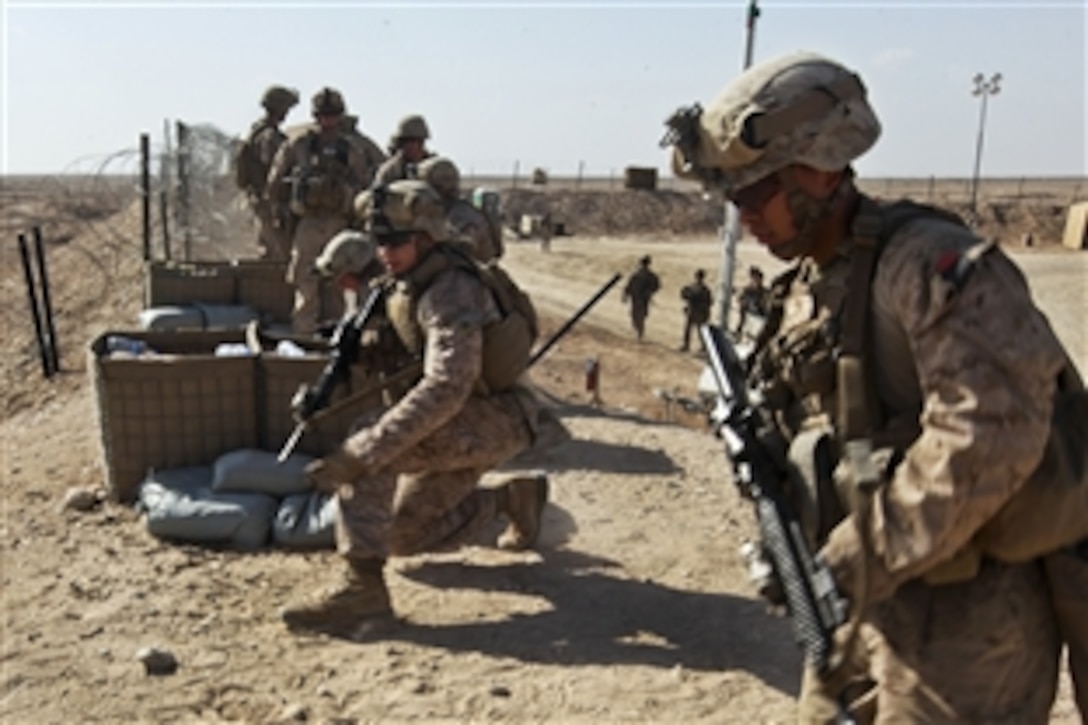 A five-man team of U.S. Marines runs to a firing position to defend against a simulated enemy insurgent attack during a live-fire training exercise on Camp Leatherneck, Afghanistan, March 6, 2014. The exercise was designed to increase confidence in locating and suppressing enemy positions. The Marines are assigned to Charlie Company, 1st Battalion, 9th Marine Regiment.