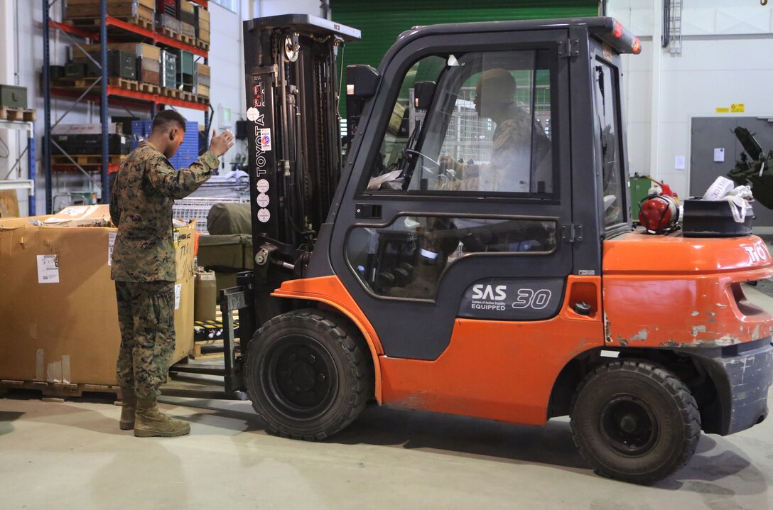 Cpl. Hussein Mohamed, a Portland, Ore., native and warehouseman with 2nd Supply Battalion, Combat Logistics Regiment 25, 2nd Marine Logistics Group, guides a forklift during equipment repackaging operations at Tromsdal, Norway, March 07, 2014. Marines removed equipment stored in cave sites for the Marine Corps Prepositioning Program – Norway to support Cold Response 2014 and future crisis-response and Marine expeditionary operations in the future. Cold Response 2014 is a Norwegian-led multinational exercise above the Arctic Circle designed prepare for crisis-response operations.
