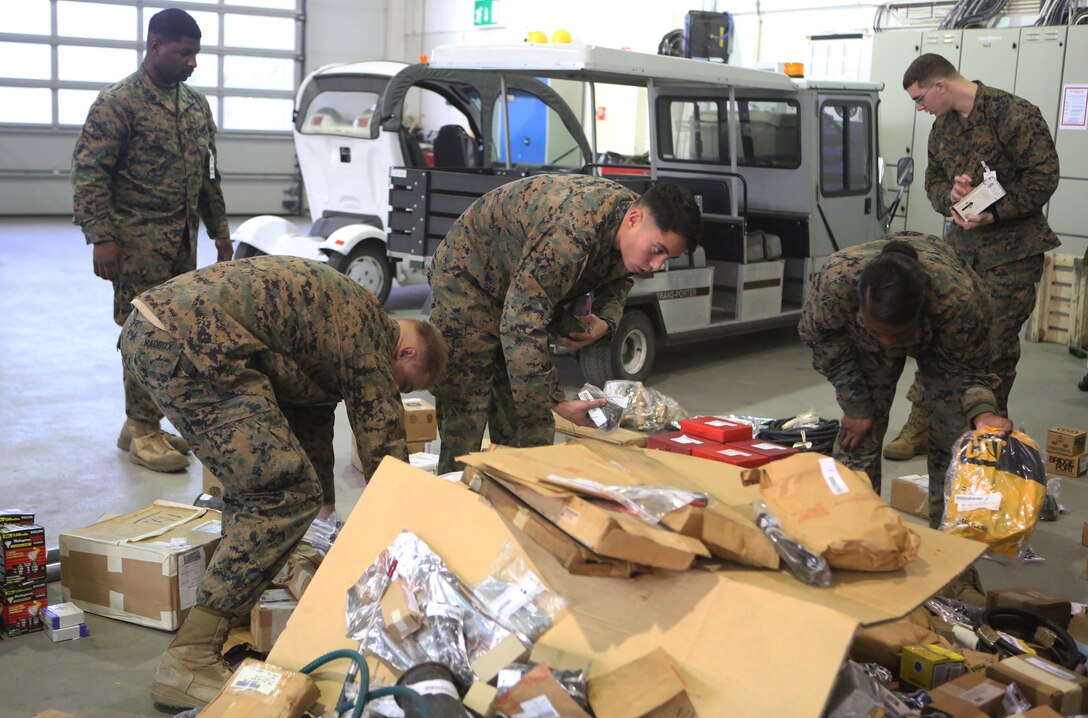 Marines with 2nd Supply Battalion, Combat Logistics Regiment 25, 2nd Marine Logistics Group sort equipment removed from an outdated storage box at Tromsdal, Norway, March 07, 2014. Marines repacked equipment stored in outdated storage boxes into plastic and metal containers, which increased the storage efficiency of the cave and allowed the equipment to be sent to more locations worldwide for the Marine Corps Prepositioning Program – Norway, which supports crisis response, humanitarian assistance and Marine expeditionary operations.