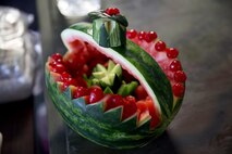 A decorative fruit basket waits to be taken out into the dining area at a field kitchen set up by Food Service Company, Combat Logistics Regiment 27, 2nd Marine Logistics Group as part of the W.P.T. Hill Award competition at a site aboard Camp Lejeune, N.C., March 10, 2014. The Marines prepared shepherd’s pie, white beans and chicken chili, and grilled steak for the main entrées. Side choices were rice, cornbread, baked potatoes and biscuits. A separate fruit and salad bar was set up as well.