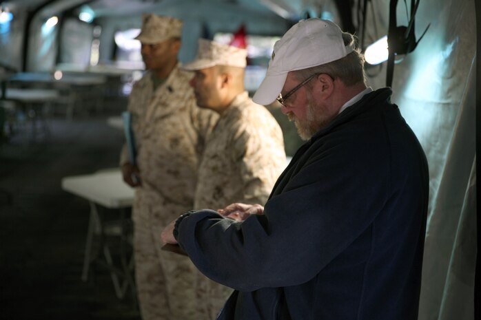 Jay Silverstein (right), the representative for the National Restaurant Association, observes the mess tent at a field mess site during the W.P.T. Hill Award competition aboard Camp Lejeune, N.C., March 10, 2014. The judges travel to the West Coast and Okinawa to inspect competing units.