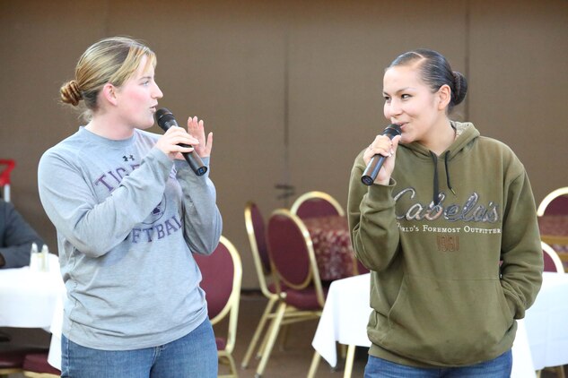 Lance Cpl. Frankie Cochran and Lance Cpl. Sarah Craig sing a duet during a karaoke event at the Clubs at Quantico on March 5, 2014. Hundreds of songs are available for participants of the weekly karaoke event. 
