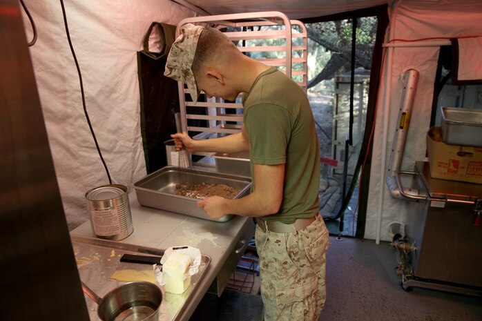 A food service specialist with Food Service Company, Combat Logistics Regiment 27, 2nd Marine Logistics Group prepares a meal for the W.P.T. Hill Award competition at a field mess site aboard Camp Lejeune, N.C., March 10, 2014. The Marines prepared shepherd’s pie, white beans and chicken chili, and grilled steak for the main entrées. Side choices were rice, cornbread, baked potatoes and biscuits. A separate fruit and salad bar was set up as well.