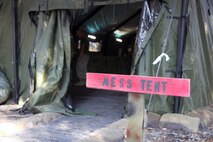 A sign in front of Food Service Company, Combat Logistics Regiment 27, 2nd Marine Logistics Group mess tent welcomes Marines and sailors before they experience the competing dishes at a field mess site during the W.P.T. Hill Award competition aboard Camp Lejeune, N.C., March 10, 2014. The Marines prepared shepherd’s pie, white beans and chicken chili, and grilled steak for the main entrées. Side choices were rice, cornbread, baked potatoes and biscuits. A separate fruit and salad bar was set up as well.
