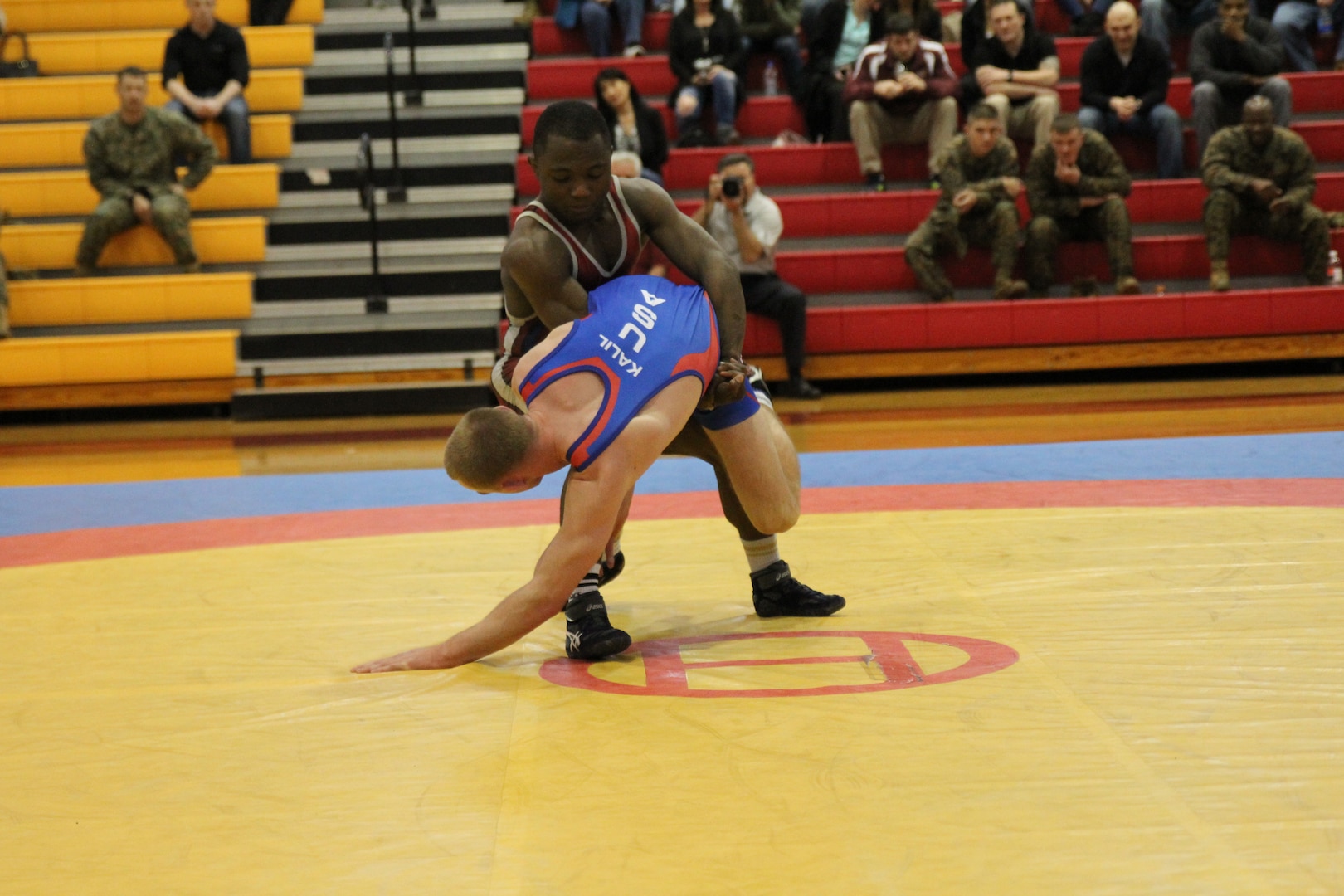 Two-time Olympian Army SGT Spencer Mango (Fort Carson, CO) throws Marine 2ndLt Aaron Kalil (Camp Lejeune, NC) during Greco-Roman competition.  Mango defeated Kalil 8-0 to win the first of his two Armed Forces gold medals (other in Freestyle) during the 2014 Armed Forces Wrestling Championship at MCB Camp Lejeune, NC 7-8 March.  