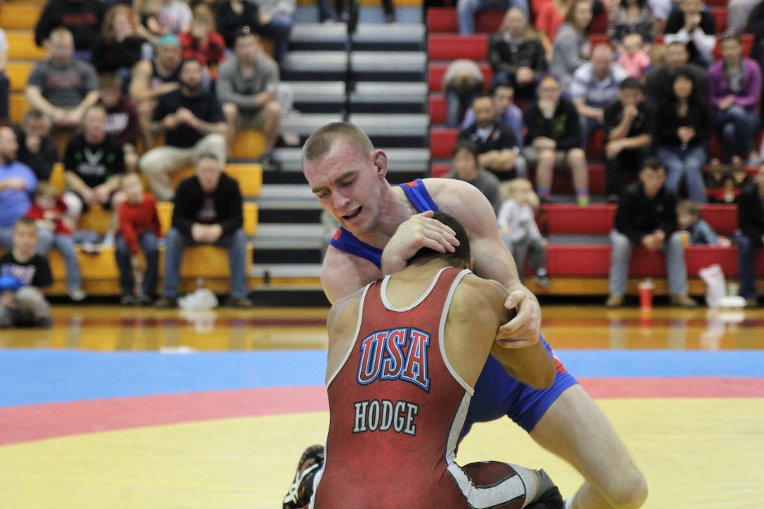 Marine 2ndLt Aaron Kalil defeats Army SPC Jermaine Hodge 6-4 in the 61kg Freestyle gold medal match.  

