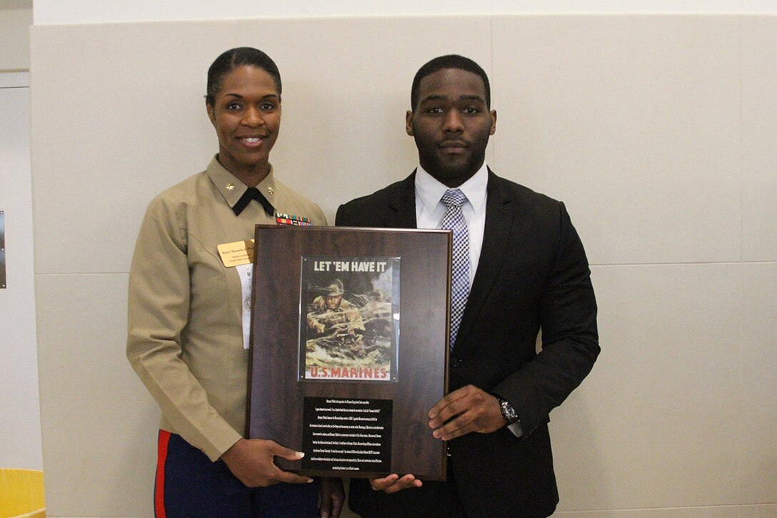 NEW ORLEANS, LA. - Derrick Martin, an Xavier University pharmacy student, is presented a Marine
Corps Leadership Award for demonstrating outstanding leadership in the
school's Youth Motivation Task Force/Black Executive Exchange Program, Feb.
25. The task force is comprised of business executives who spoke to students
about achieving goals, making yourself appealing to employers and overcoming
life challenges. (Official Marine Corps photo by Sgt. Rubin Tan)
