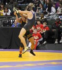 Davionte L. L. Young slams his opponent during the Minnesota State High School Wresting Competition, Feb. 27. Young is rated the number five high school wrestler at 152lbs, and although he has been offered several scholarships to various colleges, he has turned them all down to enlist in the United States Marine Corps. 