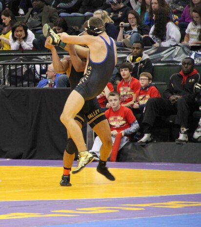 Davionte L. L. Young slams his opponent during the Minnesota State High School Wresting Competition, Feb. 27. Young is rated the number five high school wrestler at 152lbs, and although he has been offered several scholarships to various colleges, he has turned them all down to enlist in the United States Marine Corps. 