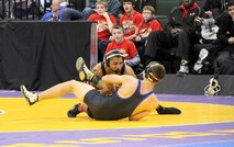 Davionte L. L. Young scrambles on top of his opponent after slamming him to the ground during the Minnesota State High School Wresting Competition, Feb. 27. Young is rated the number five high school wrestler at 152lbs, and although he has been offered several scholarships to various colleges, he has turned them all down to enlist in the United States Marine Corps. 