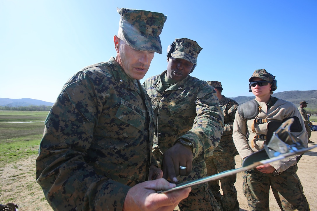 Gunnery Sgt. Jamil H. Dudley, a chemical, biological, radiological and nuclear defense specialist with Combat Logistics Regiment 1, 1st Marine Logistics Group, shows Brig. Gen. Vincent A. Coglianese, commanding general, 1st MLG, a roster detailing how his Marines performed during the 2014 Western Division matches aboard Marine Corps Base Camp Pendleton, Calif., March 5, 2014. Marines from CLRs 17, 1, 15 and 7th Engineer Support Battalion, 1st MLG, competed against approximately 200 Marines from throughout the west coast to prove their marksmanship skills with the M16 service rifle, the M4 carbine and the M9 service pistol , Feb 24 – March 7, 2014. 
