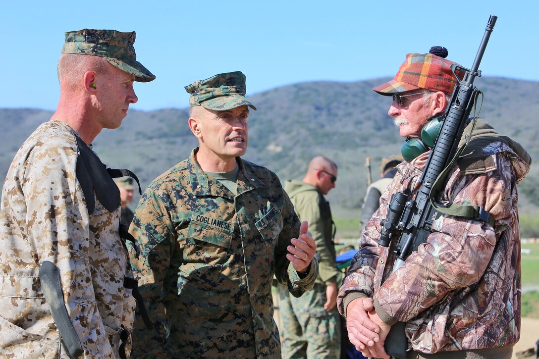 Brig. Gen. Vincent A. Coglianese, commanding general, 1st Marine Logistics Group, offers words of encouragement to Sgt. Erik A. Anderson, a motor vehicle operator with Headquarters Company, Combat Logistics Regiment 15, 1st Marine Logistics Group, and his father Elmo Anderson, as they participate in the 2014 Western Division matches aboard Marine Corps Base Camp Pendleton, Calif., March 5, 2014. Marines from CLRs 17, 1, 15 and 7th Engineer Support Battalion, 1st MLG, competed against approximately 200 Marines from throughout the west coast to prove their marksmanship skills with the M16 service rifle, the M4 carbine and the M9 service pistol, Feb 24 – March 7, 2014.