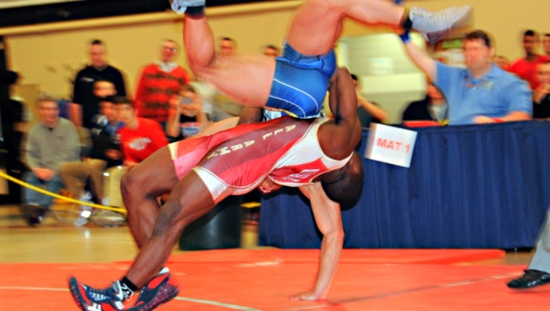 Army Spenser Mango straightlifts Navy Sheldon Wilder from the par tier position for 5 points in the Greco Roman 60 kg class March 16. Mango is stationed at Fort Carson, Colo. He hails from St. Louis, Mo. Wilder is assigned to the USS Iwo Jima in Norfolk, Va., and calls Durham, N.C., home. (U.S. Air Force photo by Senior Master Sgt. Denise Johnson/Released)