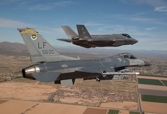 Maj. Justin Robinson flies the 56th Operations Group flagship F-16 Fighting Falcon as he escorts Luke Air Force Base's first F-35 Lightning II to the base March 10, 2014. The F-35 was flown by Col. Roderick Cregier, an F-35 test pilot stationed at Edwards AFB, Calif. Robinson is the 61st Fighter Squadron assistant director of operations. (U.S. Air Force photo/Jim Hazeltine) 