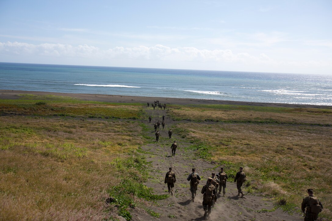 Marines with 3rd Intelligence Battalion hike to the shores of Iwo To Jan. 31 during a professional military education trip to the island. The beaches of Iwo To are known for the distinctive, black sand. 3rd Intel. Bn. is with III Marine Expeditionary Force Headquarters Group, III MEF. 