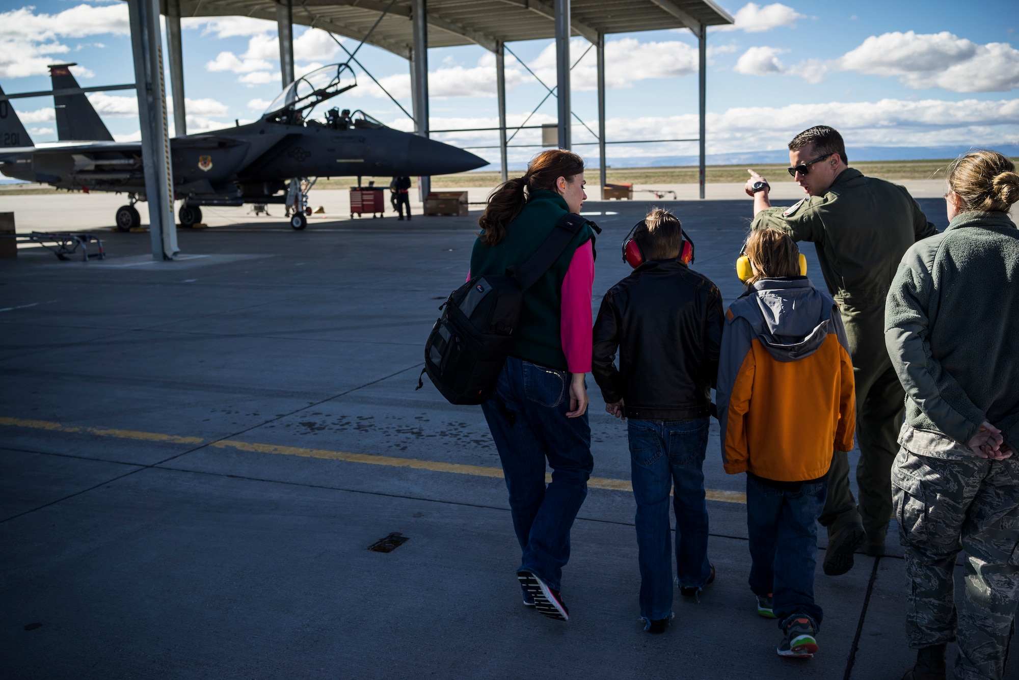 U.S. Air Force 1st Lt. Andrew Morton, 389th Fighter Squadron pilot, points to an aircraft as he describes the pre-flight procedures for the F-15E Strike Eagle at Mountain Home Air Force Base, Idaho, March 7, 2014. William Ciluaga, also known as "Idaho William," asked Morton about his experiences as a pilot and what makes the F-15E unique. (U.S. Air Force photo by Tech. Sgt. Samuel Morse/RELEASED)