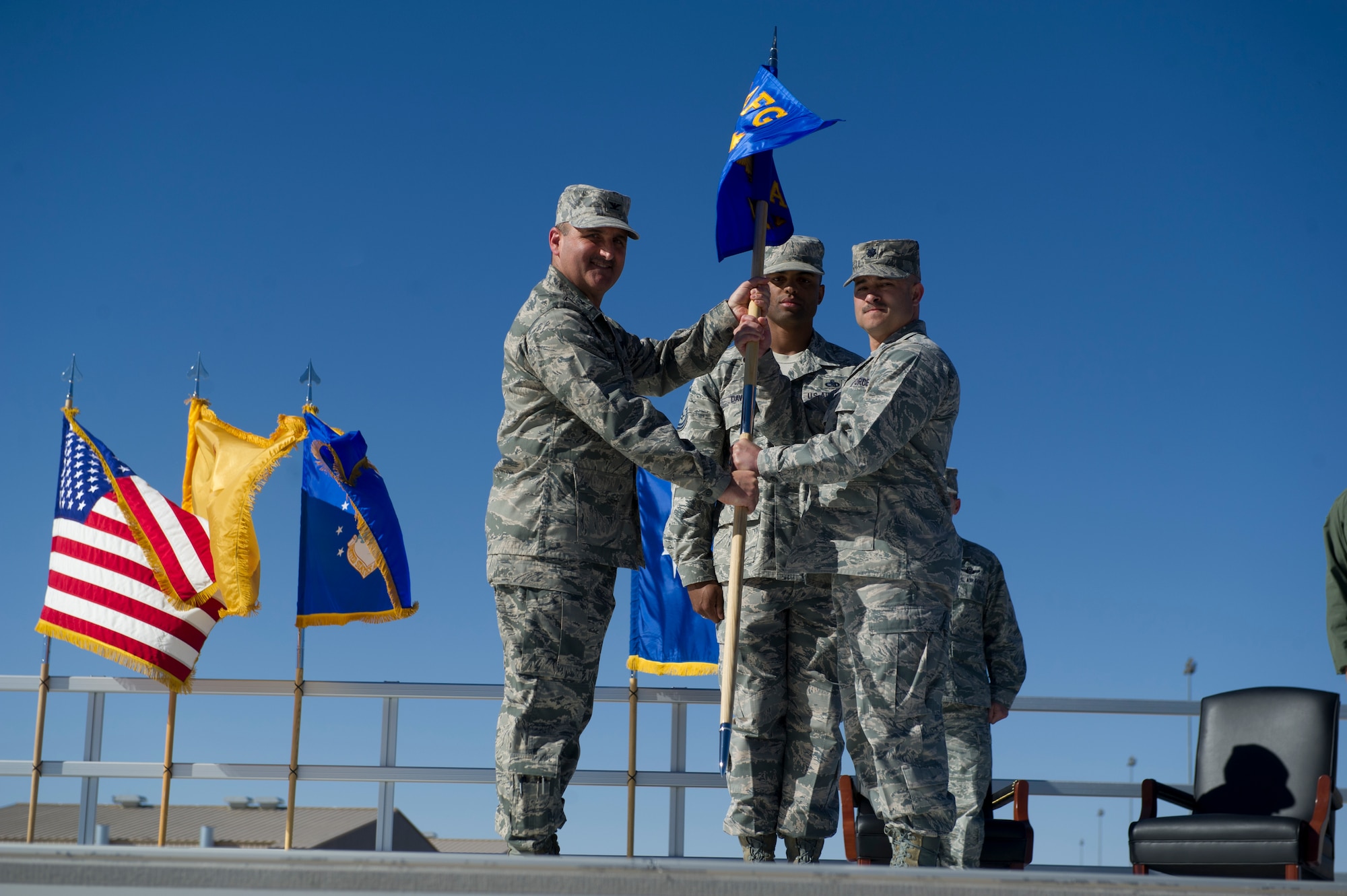 Col. Rodney Petithomme, 54th Fighter Group commander, passes the guidon of the 54th Aircraft Maintenance Squadron to Lt. Col. Dominick Martin during the 54th Fighter Group at Holloman Air Force Base, N.M., March 11. The 54th Fighter Group, a tenant unit at Holloman, is a detachment the 56th Fighter Wing at Luke Air Force Base, Ariz., and will ultimately operate two F-16 Fighting Falcon aircraft training squadrons. The 54th Fighter Group plus three squadrons were activated at the ceremony: the 311th Fighter Squadron, the 54th Operations Support Squadron and the 54th Aircraft Maintenance Squadron. (U.S. Air Force photo by Airman 1st Class Chase A. Cannon/Released)