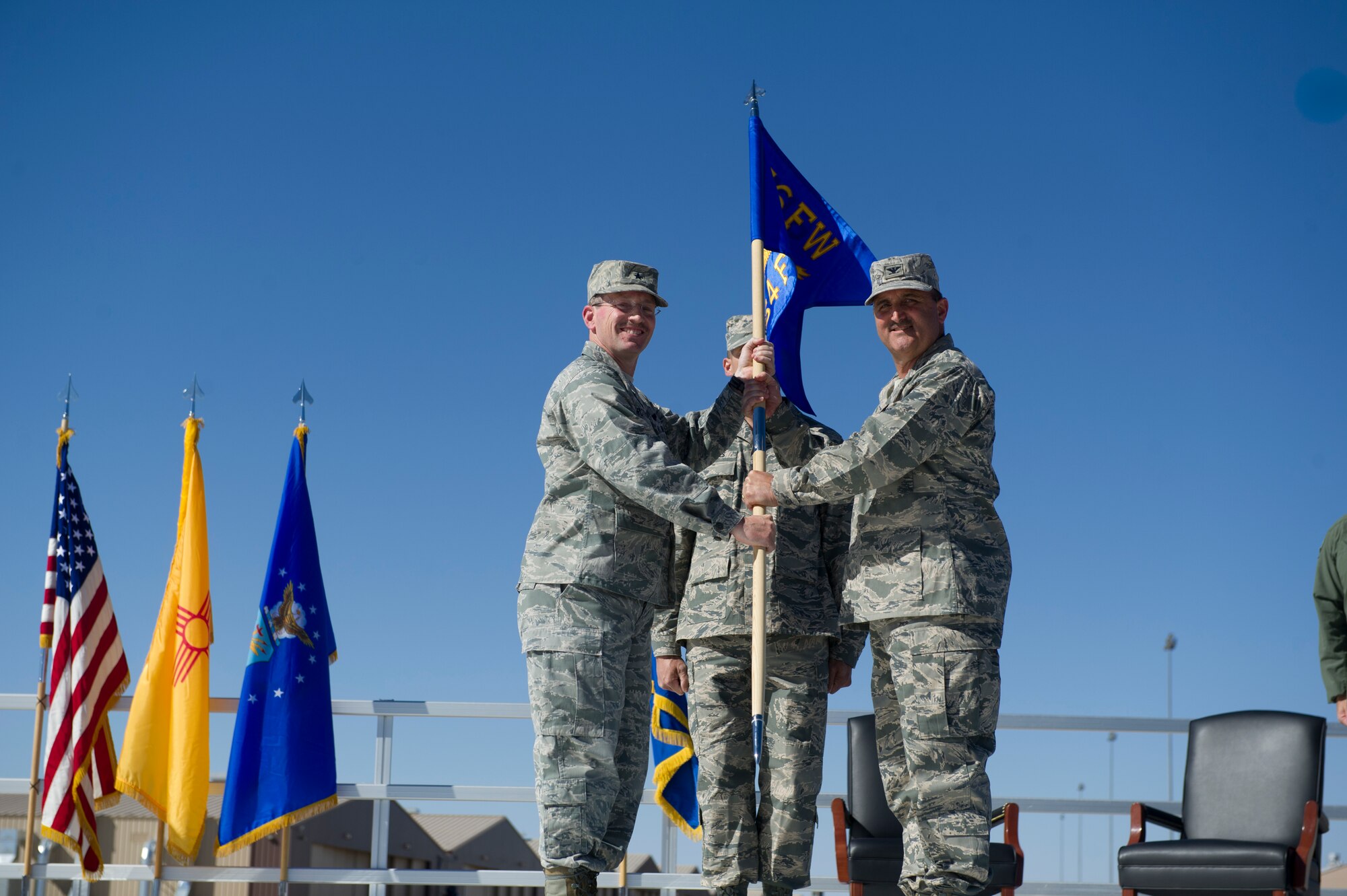 Brigadier Gen. Michael Rothstein, 56th Fighter Wing commander, passes the guidon of the 54th Fighter Group to Col.l Rodney Petithomme during the 54th Fighter group activation ceremony at Holloman Air Force Base, N.M., March 11. The 54th Fighter Group, a tenant unit at Holloman, is a detachment the 56th Fighter Wing at Luke Air Force Base, Ariz., and will ultimately operate two F-16 Fighting Falcon aircraft training squadrons. The 54th Fighter Group plus three squadrons were activated at the ceremony: the 311th Fighter Squadron, the 54th Operations Support Squadron and the 54th Aircraft Maintenance Squadron. (U.S. Air Force photo by Airman 1st Class Chase A. Cannon/Released)