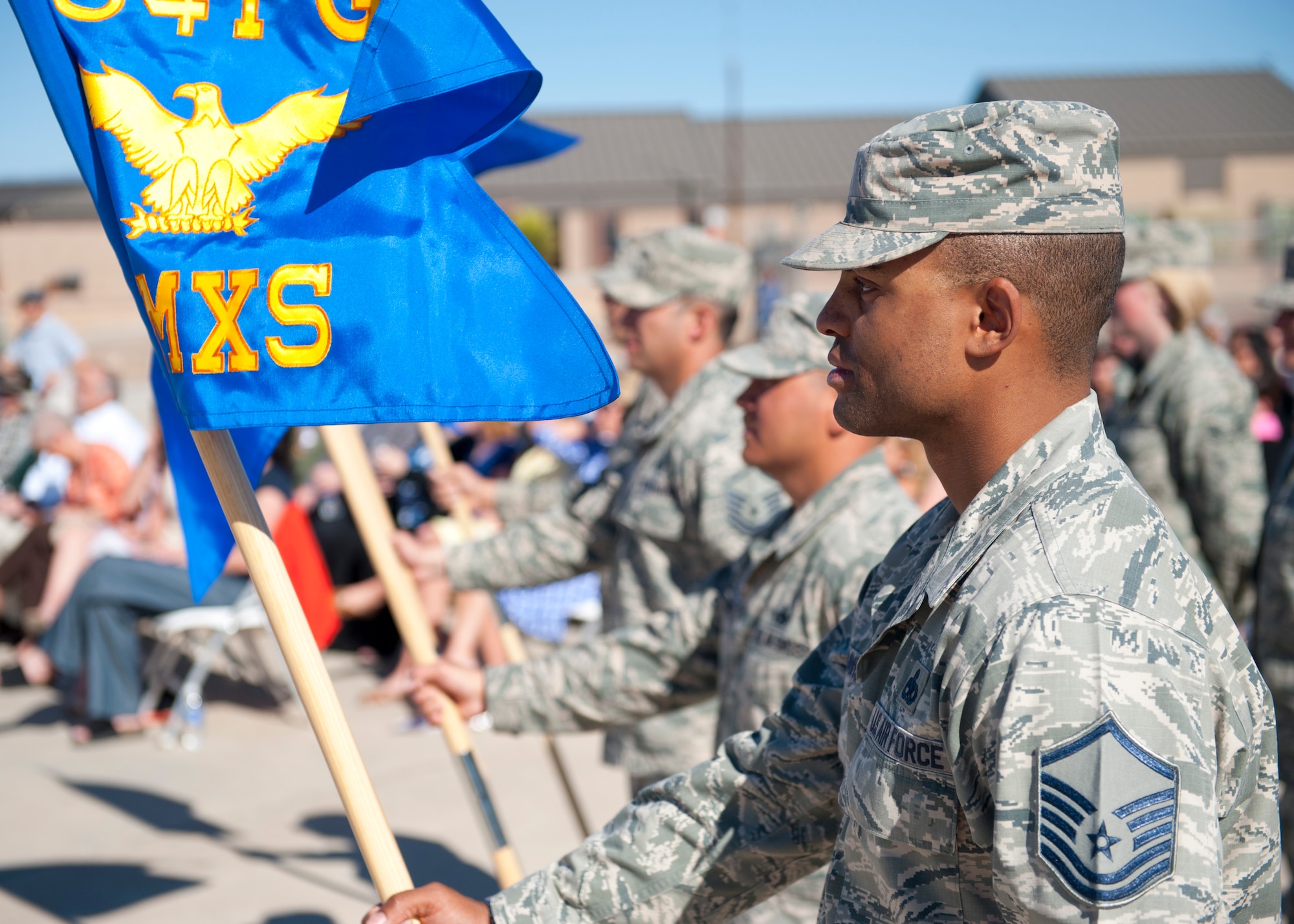 Airmen stand in formation with their squadron guidons during the 54th Fighter Group activation ceremony at Holloman Air Force Base, N.M., March 11. The 54th Fighter Group, a tenant unit at Holloman, is a detachment the 56th Fighter Wing at Luke Air Force Base, Ariz., and will ultimately operate two F-16 Fighting Falcon aircraft training squadrons. The 54th Fighter Group plus three squadrons were activated at the ceremony: the 311th Fighter Squadron, the 54th Operations Support Squadron and the 54th Aircraft Maintenance Squadron. (U.S. Air Force photo by Senior Airman Daniel E. Liddicoet/Released)