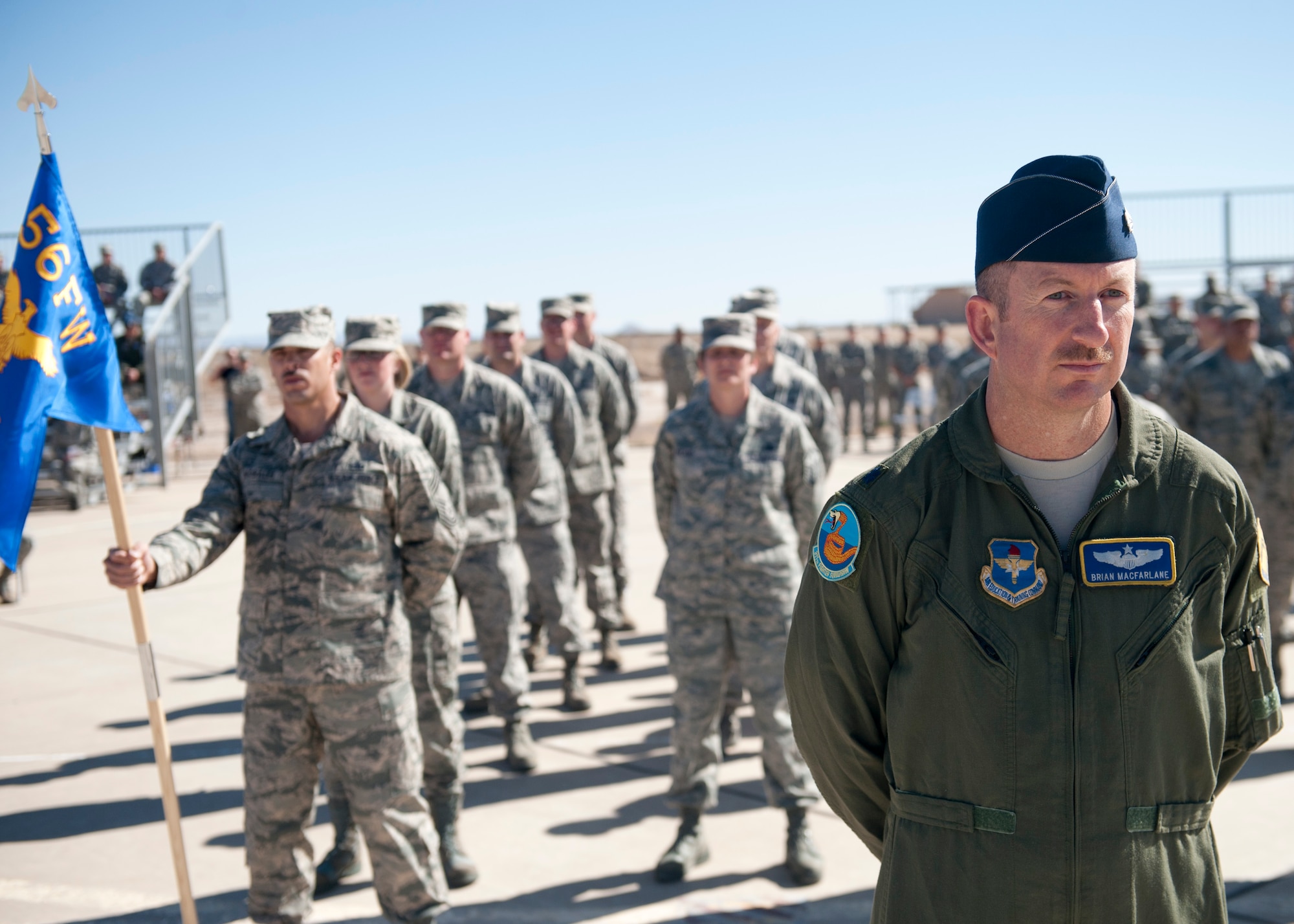 Lieutenant Col. Brian Macfarlane, 54th Operation Support Squadron director of operations, stands in formation with the new Airmen of the 54th Fighter Group at Holloman Air Force Base, N.M., March 11. The 54th Fighter Group, a tenant unit at Holloman, is a detachment the 56th Fighter Wing at Luke Air Force Base, Ariz., and will ultimately operate two F-16 Fighting Falcon aircraft training squadrons. The 54th Fighter Group plus three squadrons were activated at the ceremony: the 311th Fighter Squadron, the 54th Operations Support Squadron and the 54th Aircraft Maintenance Squadron. (U.S. Air Force photo by Senior Airman Daniel E. Liddicoet/Released)
