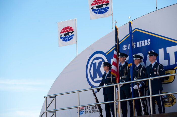 Members of the Nellis Air Force Base Honor Guard present the colors during opening ceremonies at the Kobalt 400 NASCAR race March 9, 2014, at Las Vegas Motor Speedway, Las Vegas, Nev. More than 3,000 Airmen participated in the festivities, as spectators and volunteers alike. (U.S. Air Force photo by Airman First Class Joshua Kleinholz)