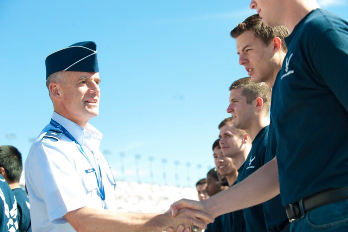 Brig. Gen.  Jay Silveria, U. S. Air Force Warfare Center commander, greets Air Force recruits prior to administering the Oath of Enlistment during opening ceremonies at the Kobalt 400 NASCAR race March 9, 2014, at Las Vegas Motor Speedway, Las Vegas, Nev. The recruits took the oath in front of a crowd of approximately 60,000 people. (U.S. Air Force photo by Airman First Class Joshua Kleinholz)