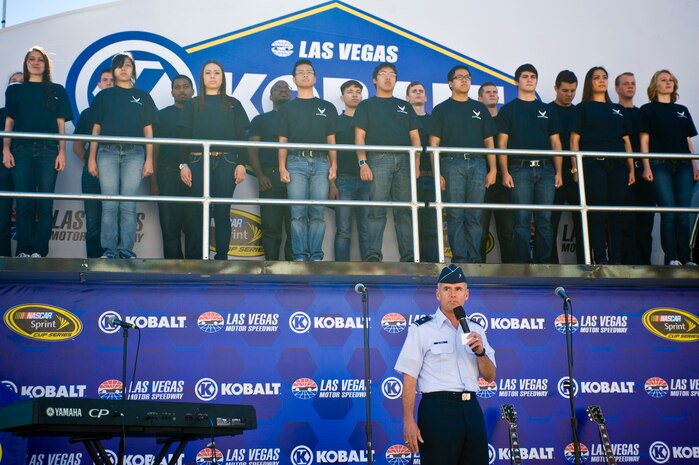 Brig. Gen. Jay Silveria, U.S. Air Force Warfare Center commander, administers the Oath of Enlistment to U.S. Air Force delayed entry program members before the Kobalt 400 NASCAR race March 9, 2014, at the Las Vegas Motor Speedway in Las Vegas. The U.S. Air Force delayed entry program is for members waiting to go to basic training. (U.S. Air Force photo by Airman 1st Class Jake Carter)