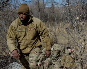 U.S. Air Force Tech. Sgt. JT May climbs a slope off of the Snake River in Grand View, Idaho, March 11, 2014. May was participating in a scenario during Gunfighter Flag, a weeklong exercise designed to prepare joint and coalition terminal attack controller teams for upcoming deployments as well as provide proficiency training for aircrews. (U.S. Air Force photo by Airman 1st Class Brittany A. Chase/Released)