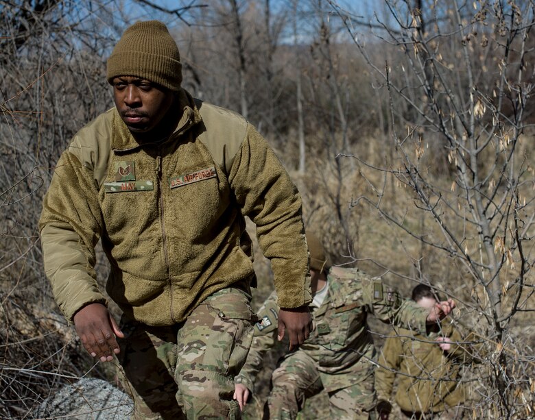 U.S. Air Force Tech. Sgt. JT May climbs a slope off of the Snake River in Grand View, Idaho, March 11, 2014. May was participating in a scenario during Gunfighter Flag, a weeklong exercise designed to prepare joint and coalition terminal attack controller teams for upcoming deployments as well as provide proficiency training for aircrews. (U.S. Air Force photo by Airman 1st Class Brittany A. Chase/Released)