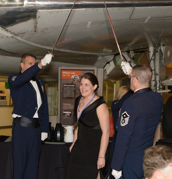 Coleen Gause, Spouse of the Year, walks through a saber team arch led by first sergeants to accept her award at the 446th Airlift Wing Annual Awards Banquet March 8 at Boeing’s Museum of Flight in Seattle.  Mrs. Gause, mother of three, was nominated by her husband, 1st Lt. Gregory Gause, 313th Airlift Squadron pilot, because of her continued support and understanding she has shown for the past three years while he was in pilot training.  (Courtesy photo by David Lobban, Lobban Photography Inc.)