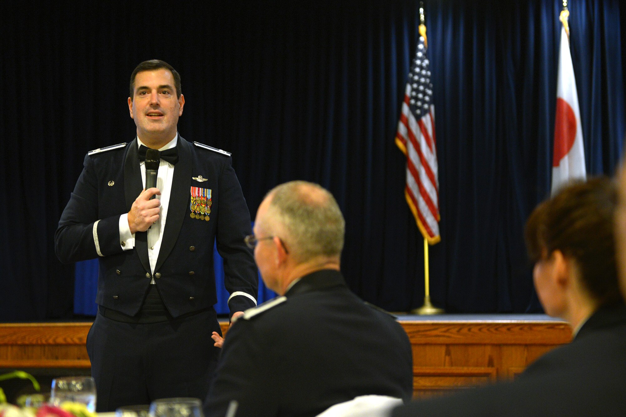Col. Mark August, 374th Airlift Wing commander, congratulates 2013 annual award winners at Yokota Air Base, Japan, Feb. 28, 2014. The annual awards banquet recognizes Yokota members who performed above and beyond the day-to-day requirements on a regular basis. (U.S. Air Force photo by Airman 1st Class David Danford/Released)