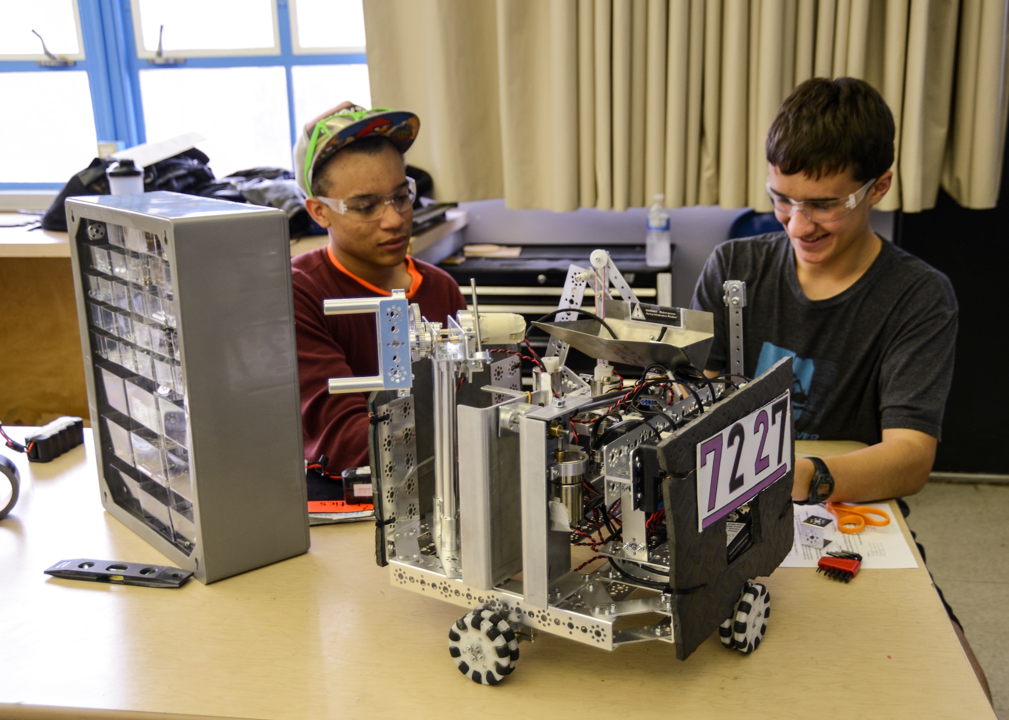 The Scorpions Robotics team named their robot, Scoop Da Whoop, after the scooping mechanism attached to the top of the robot, which helps the team achieve one of the game objectives to move small square pieces from the playing field to a series of baskets attached to a pendulum. The team receives additional points if they can use the blocks to balance the pendulum. (U.S. Air Force photo by Rebecca Amber)