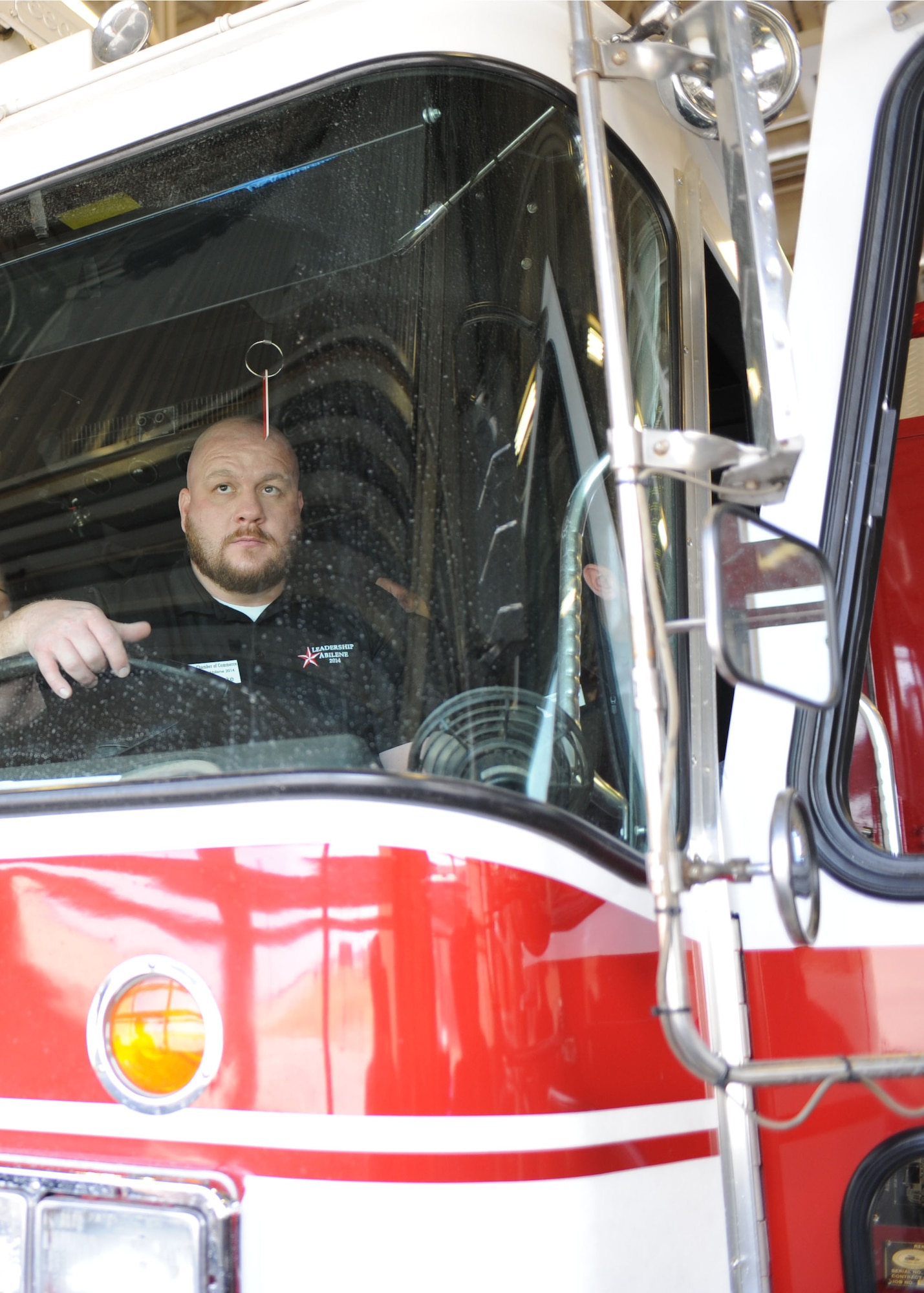 John Jeziorske, Leadership Abilene member, sits in a fire truck March 7, 2014, at Dyess Air Force Base, Texas. Members of Leadership Abilene toured the fire station here, where they learned about the daily operations of Dyess firefighters and how they can assist the Abilene community when necessary. (U.S. Air Force photo by Senior Airman Shannon Hall/Released)