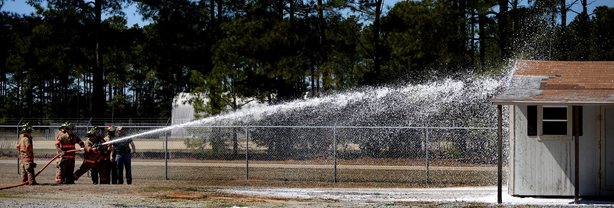 U.S. Air Force firefighters assigned to the 20th Civil Engineer Squadron, test the new compressed air foam system on a building, Shaw Air Force Base, S.C., March 10, 2014. Approximately 10 Airman spent the day learning to use the new CAF system, which they are now qualified to use and will be put into effect immediately. (U.S. Air Force photo by Airman 1st Class Michael A. Cossaboom/Released) 