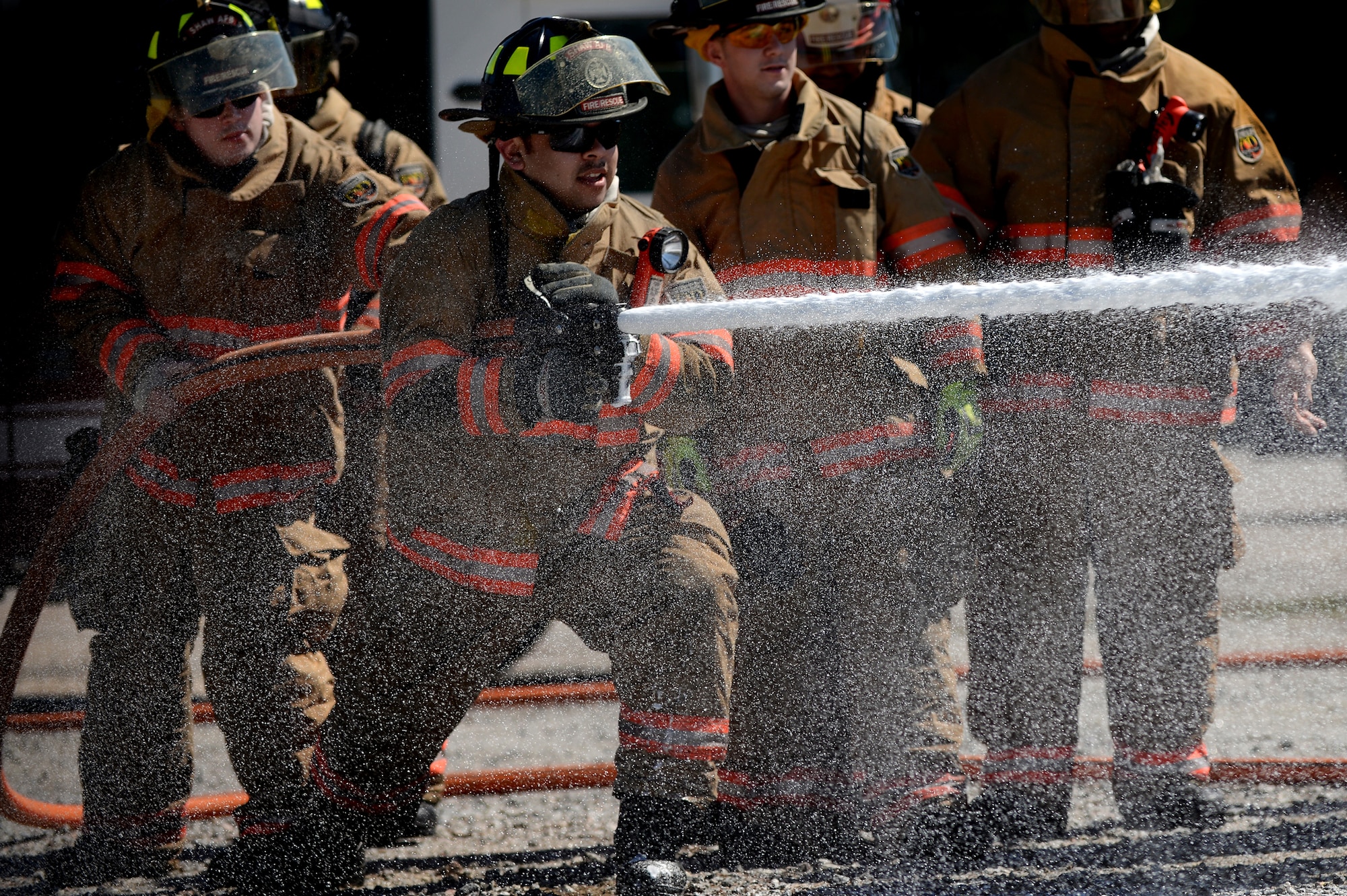 Airman 1st Class Raymond Aguilar, 20th Civil Engineer Squadron firefighter, tests the force of the new compressed air foam system, Shaw Air Force Base, S.C., March 10, 2014. The new CAF system will assist firefighters in extinguishing fires faster than using water. (U.S. Air Force photo by Airman 1st Class Michael A. Cossaboom/Released)