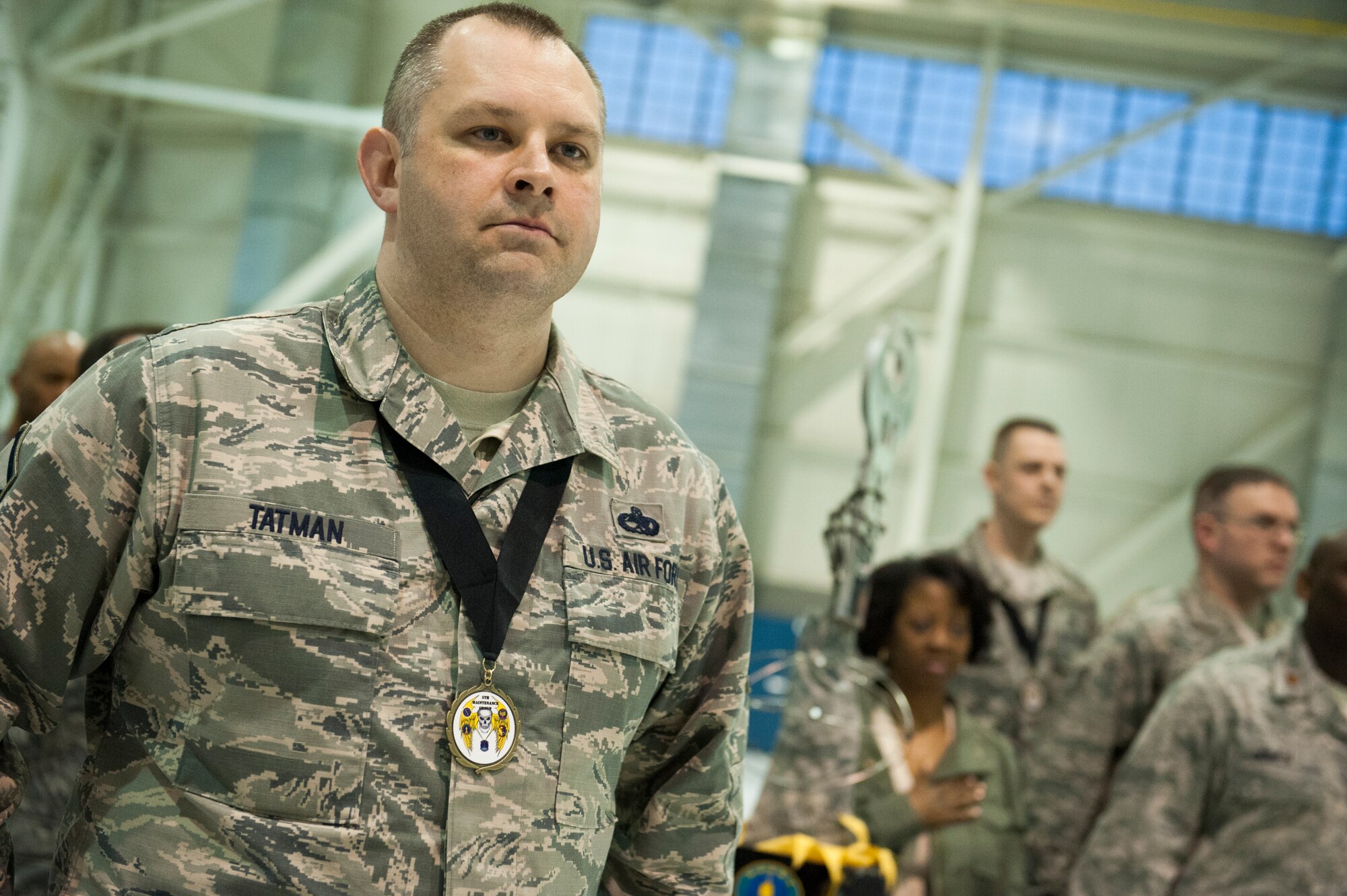 Master Sgt. Elijah Tatman, inspection section chief from the 5th Maintenance Squadron, stands at attention during the National Anthem at the Maintenance Professional of the Year banquet at Minot Air Force Base, N.D., Feb. 7, 2014. The MPOY banquet recognizes the achievements of the maintenance group and honors maintenance professionals each year.  (U.S. Air Force photo/Airman 1st Class Sahara L. Fales)
