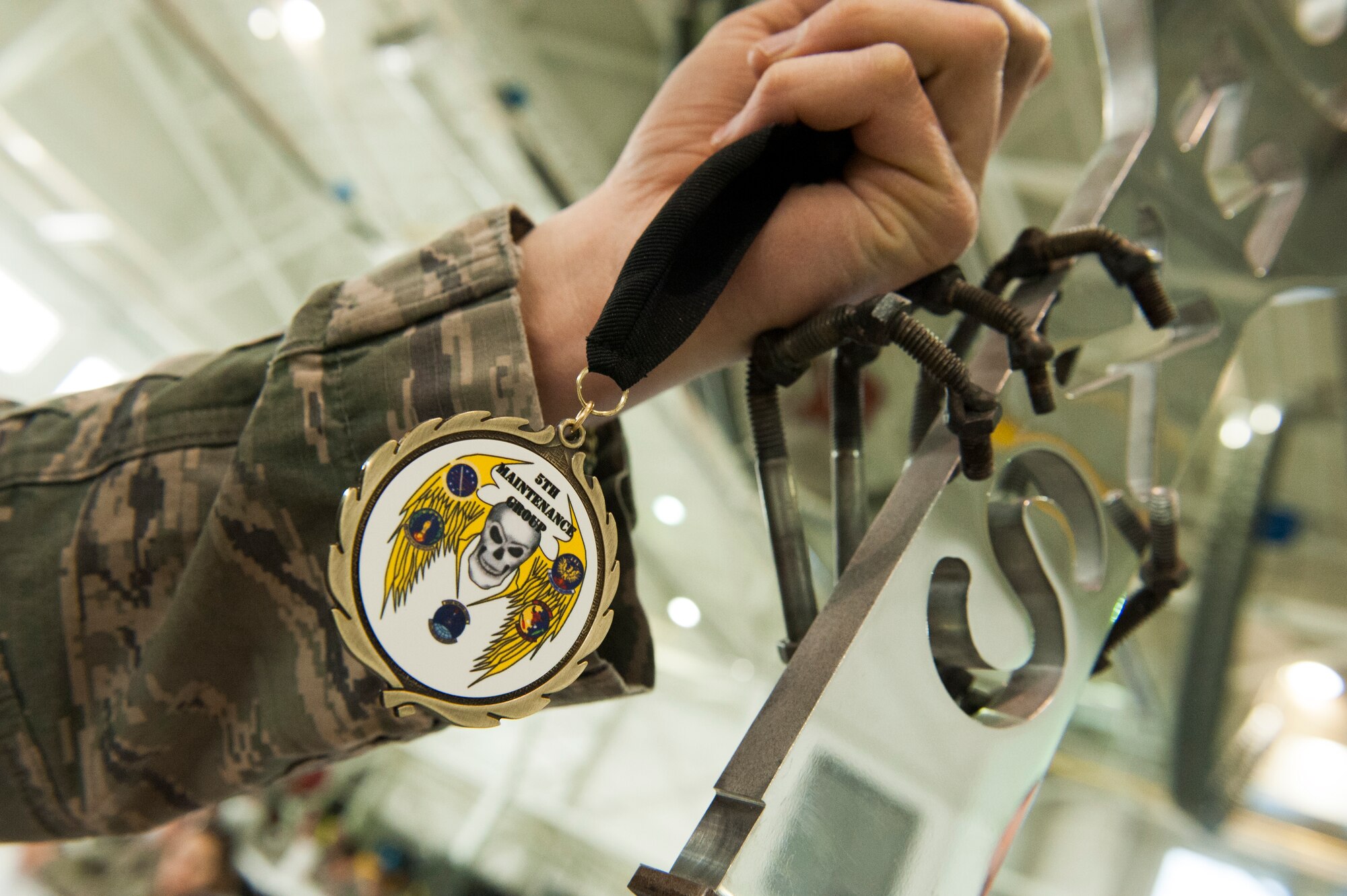 An Airman from the 5th Maintenance Squadron holds his nominee medallion during the Maintenance Professional of the Year banquet at Minot Air Force Base, N.D., Feb. 7, 2014. The MPOY banquet recognizes the achievements of the maintenance group and honors maintenance professionals each year.  (U.S. Air Force photo/Airman 1st Class Sahara L. Fales)