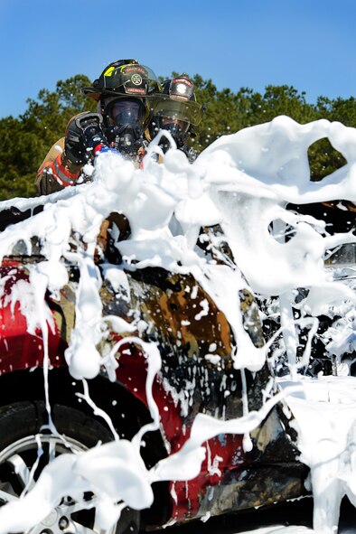 U.S Air Force Senior Airmen Brandon Young and Senior Airman Wesley Martin, 20th Civil Engineer Squadron firefighters, extinguish a controlled car fire using compressed air foam at Shaw Air Force Base, S.C., March 10, 2014. The 20th CES firefighters trained with a new CAF system, which covers a fire with millions of bubbles extinguishing it as well as cool the structure down. (U.S. Air Force photo by Airman 1st Class Jensen Stidham/Released)