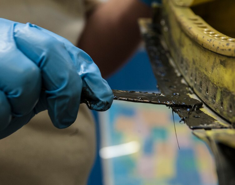 B 1/2 epoxy is applied to part of a B-52H Stratofortress at Minot Air Force Base, N.D., March 6, 2014. Epoxies are the most commonly used structural adhesives because of their strength and their ability to resist weather, chemicals and solvents, and extreme temperatures. (U.S. Air Force photo/Senior Airman Stephanie Sauberan)