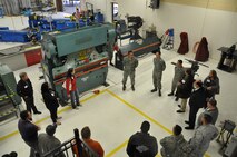 Tech. Sgt. Juan Gonzalez, (center left) a structural maintenance technician, 433rd Maintenance Squadron, Joint Base San Antonio-Lackland gives a tour of the Structural Maintenance shop to Reserve civilian employees, during Employer Orientation Day, March 8, 2014. The goal of Employer Orientation Day is to help employers better understand the Air Force mission, to see their employees perform their military duties and to strengthen the employer and reservist relationship. (U.S. Air Force photo by Tech Sgt. Carlos J. Trevino)