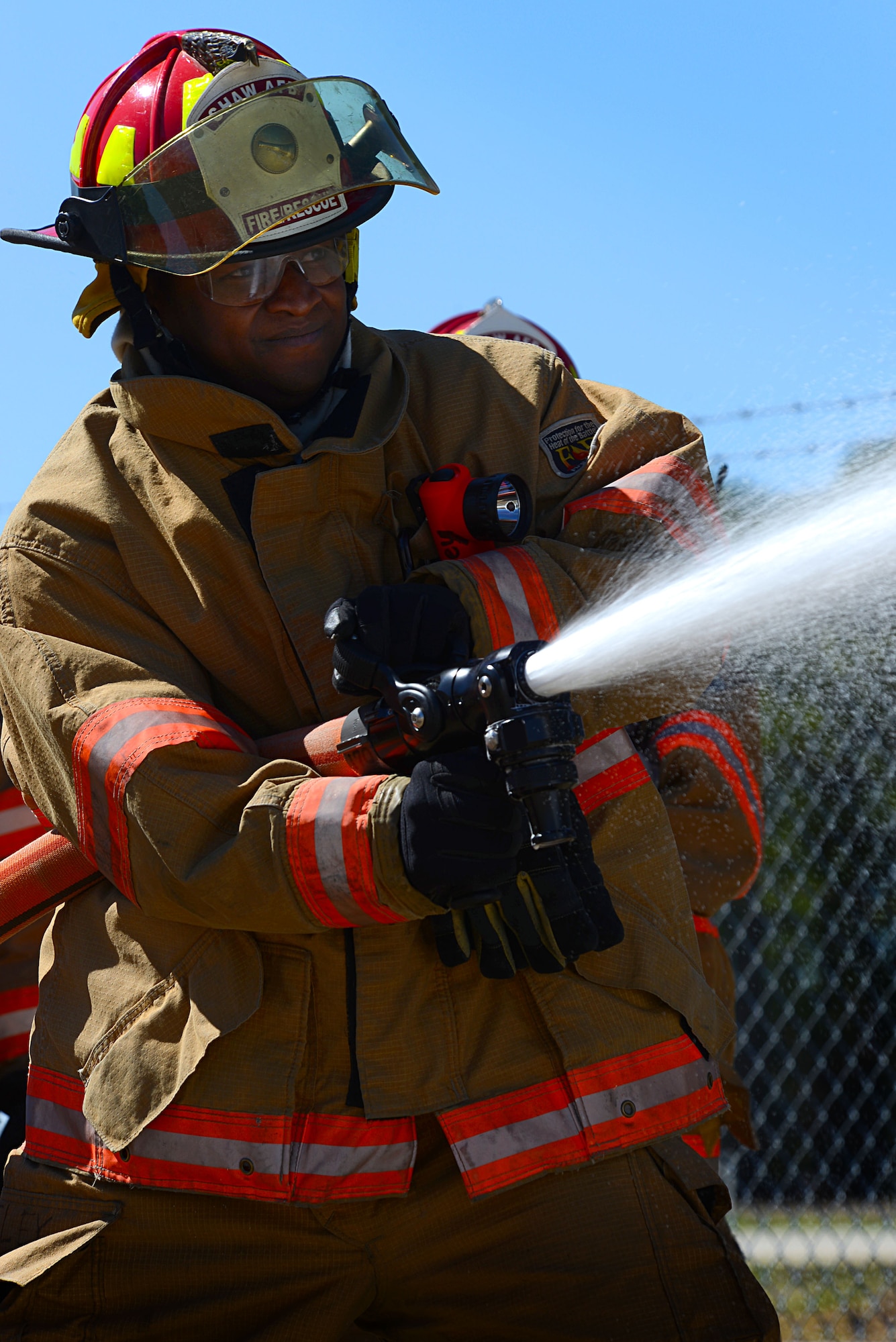 U.S. Air Force Staff Sgt. Patrick Bentley, 20th Civil Engineer Squadron firefighter, trains with compressed air foam at Shaw Air Force Base, S.C., March 10, 2014. The new CAF system is a way of cooling down a fire by producing millions of bubbles that trap British thermal units, which are the amount of heat required to raise the temperature of one pound of water. (U.S. Air Force photo by Airman 1st Class Jensen Stidham/Released)