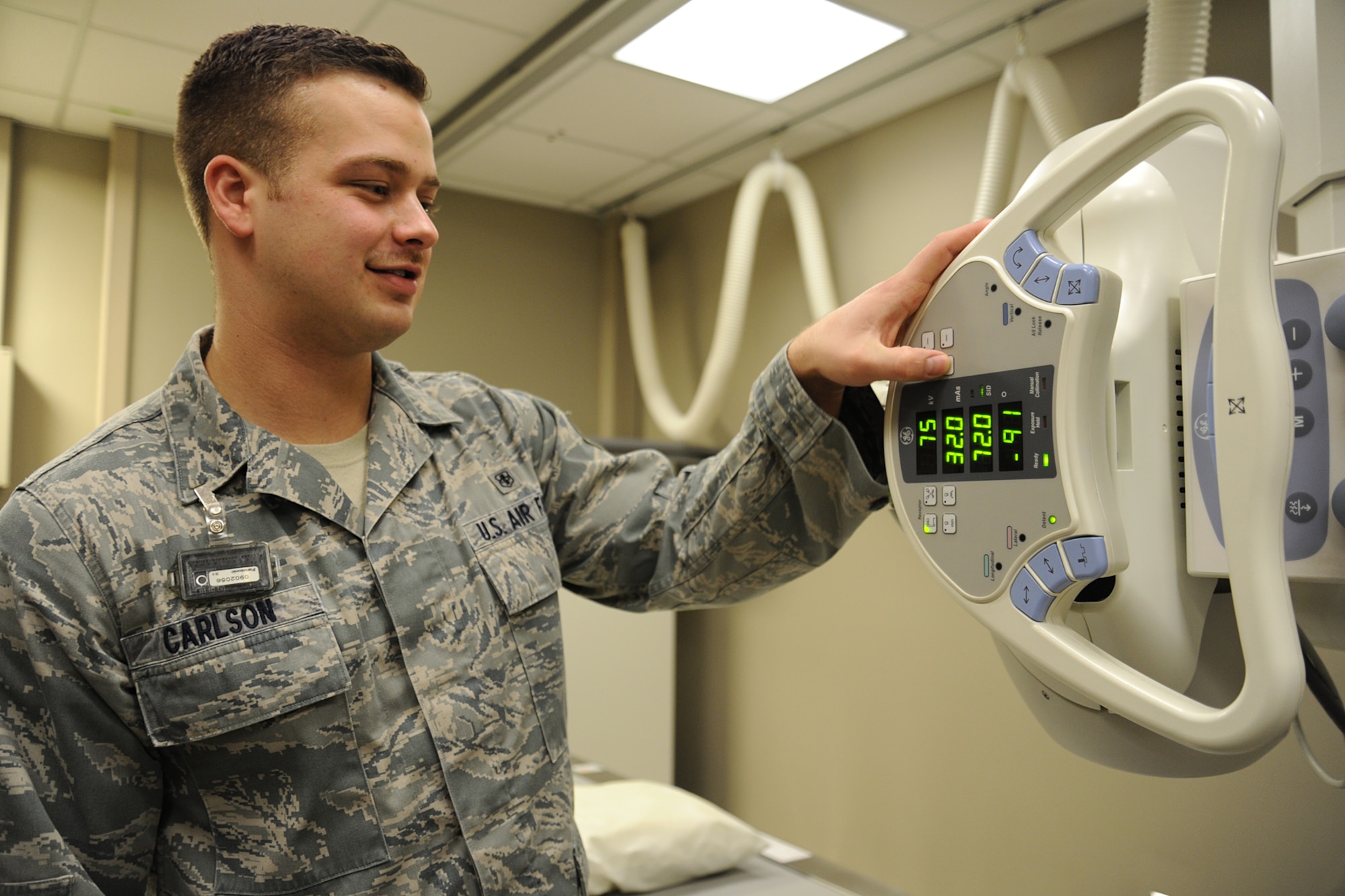 Senior Airman Timothy Carlson, 92nd Medical Support Squadron radiology technologist, adjusts technique to compensate for body habitus during an x-ray at Fairchild Air Force Base, Wash., March 10, 2014. The radiology department is partnered with Spokane Veterans Affairs Medical Center and Travis AFB to train in specialty imaging. (U.S. Air Force photo by Airman 1st Class Janelle Patiño/Released)