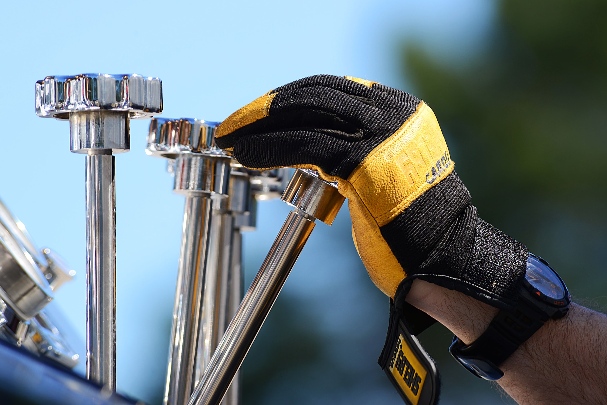 A 20th Civil Engineer Squadron firefighter, pulls a lever controlling compressed air foam at Shaw Air Force Base, S.C., March 10, 2014. The three tank system is a mixture of air, foam and water which cools down a structure that is on fire by producing millions of bubbles that trap British thermal units, which are the amount of heat required to raise the temperature of one pound of water. (U.S. Air Force photo by Airman 1st Class Jensen Stidham/Released)