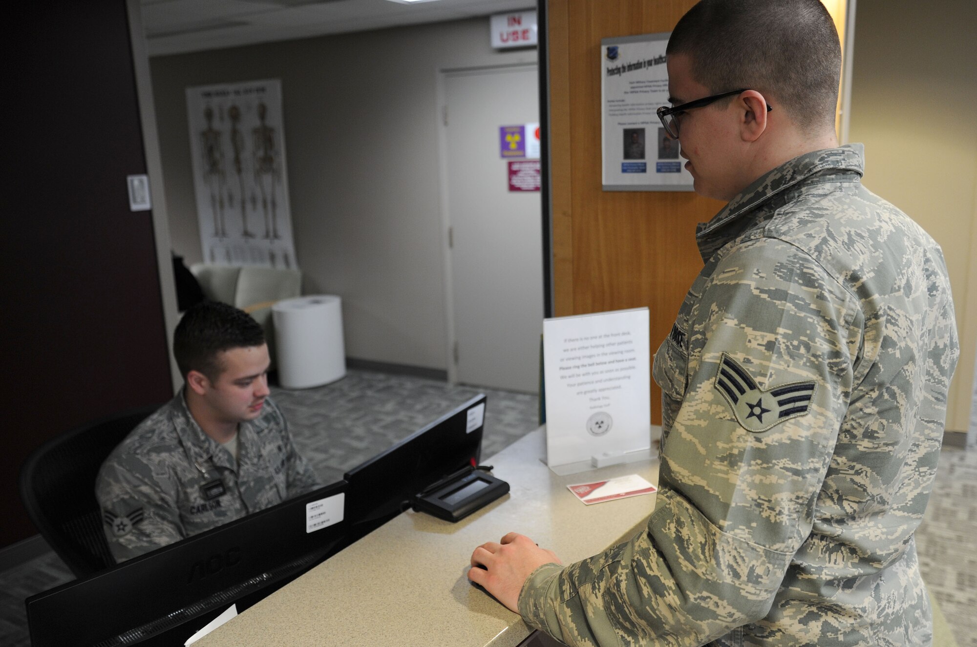 Senior Airman Timothy Carlson, 92nd Medical Support Squadron radiology technologist, checks in a patient at the Diagnostic Imaging clinic at Fairchild Air Force Base, Wash., March 10, 2014. The radiology department is open Monday through Friday from 7:30 a.m. - 4:30 p.m. (U.S. Air Force photo by Airman 1st Class Janelle Patiño/Released)