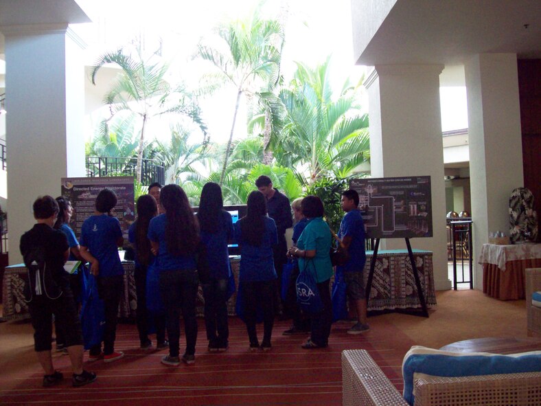 AFRL researchers explain the concepts of green computing to a group of Maui 7th grade students at the Air Force Maui Optical and Supercomputing Conference in September 2013.  In 2013, Riptide was ranked No. 120 in the Top Green 500 List of the most energy efficient supercomputers in the world. (AFRL Image)