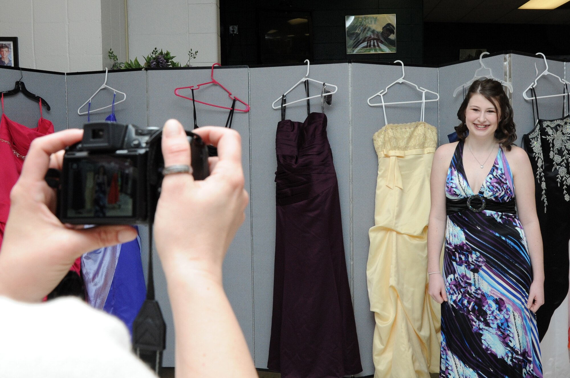 Toria Knox has her "after" photo taken in her newly chosen prom dress at the 319th Force Support Squadron Prom Prep Academy event at the Youth Center on Grand Forks Air Force Base, N.D., March 8, 2014. More than 25 girls attended the event, with high school-age participants getting to choose a donated dress and all learning about makeup and hairstyles. (U.S. Air Force photo/Staff Sgt. David Dobrydney)
